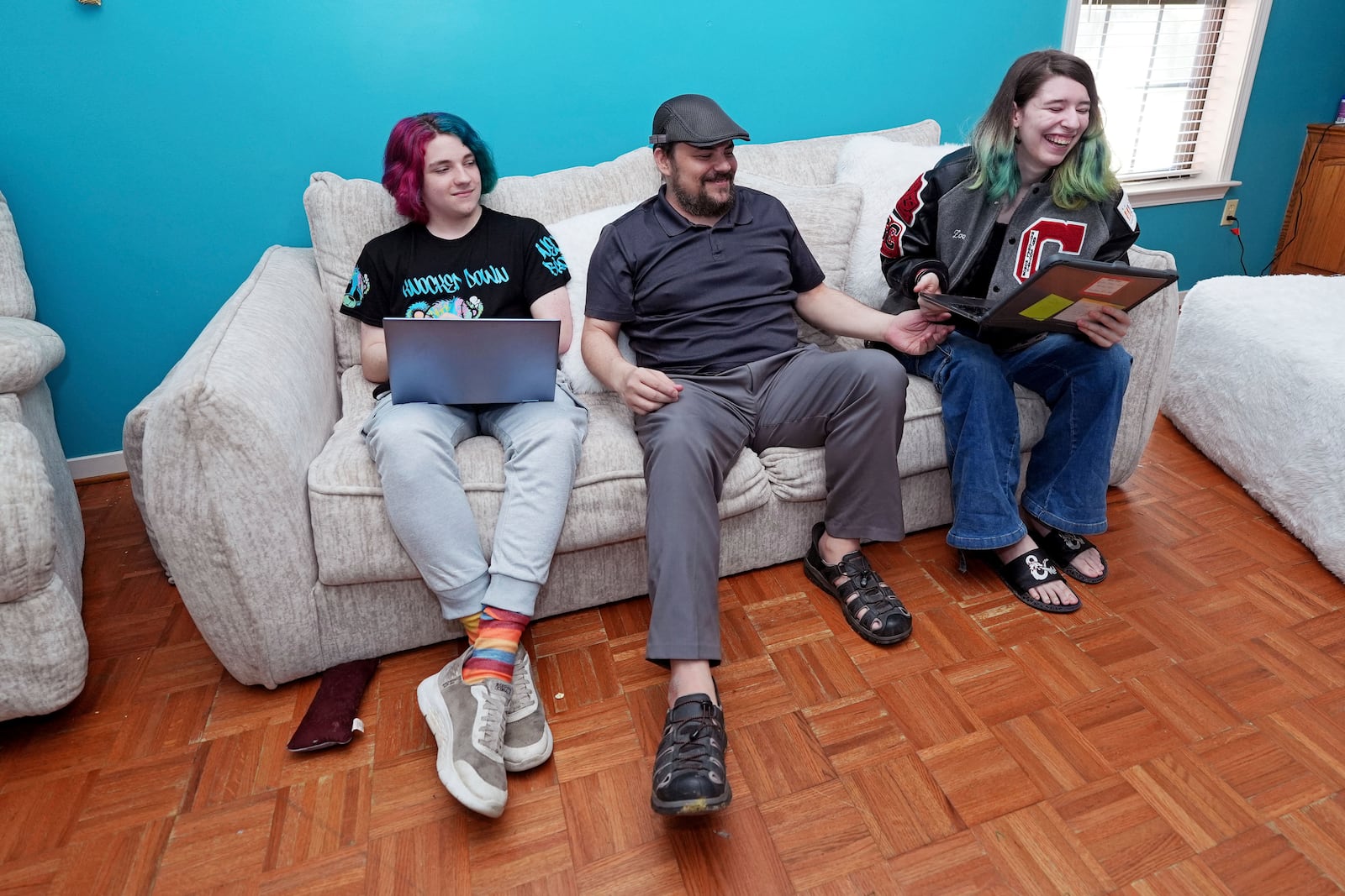 Tim Reiland, 42, center, the parent of daughter Zoe Reiland, 17, right, and Anakin Reiland, 15, photographed in Clinton, Miss., Monday, March 10, 2025, said he had no idea their previous schools, in Oklahoma, were using surveillance technology to monitor the students. (AP Photo/Rogelio V. Solis)