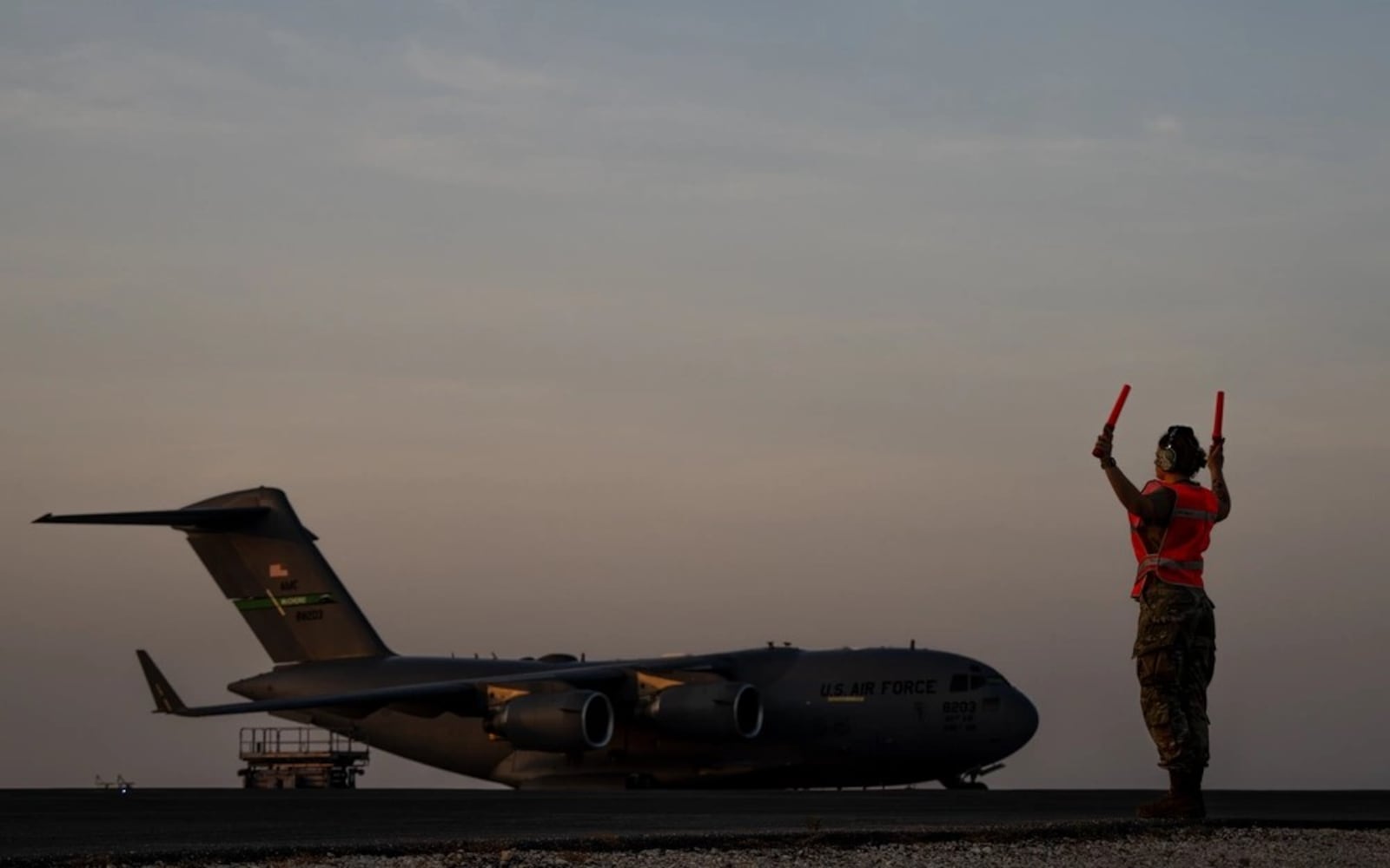 U.S. Air Force Tech. Sgt. Molly Hageman, marshals a C-17 Globemaster III on the flight line at an undisclosed location within the U.S. Central Command area of responsibility, Nov. 28, 2023. (U.S. Air Force photo by Tech. Sgt. Alexander Cook)