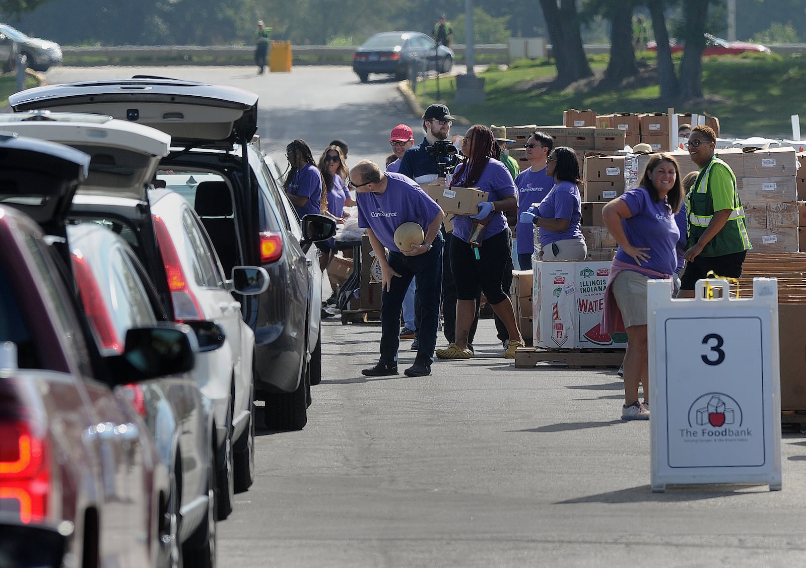 The Foodbank hosted a large drive-thru food distribution event Tuesday, Aug. 29, 2023, in the parking lot of Welcome Stadium, next to the University of Dayton Arena. MARSHALL GORBY\STAFF