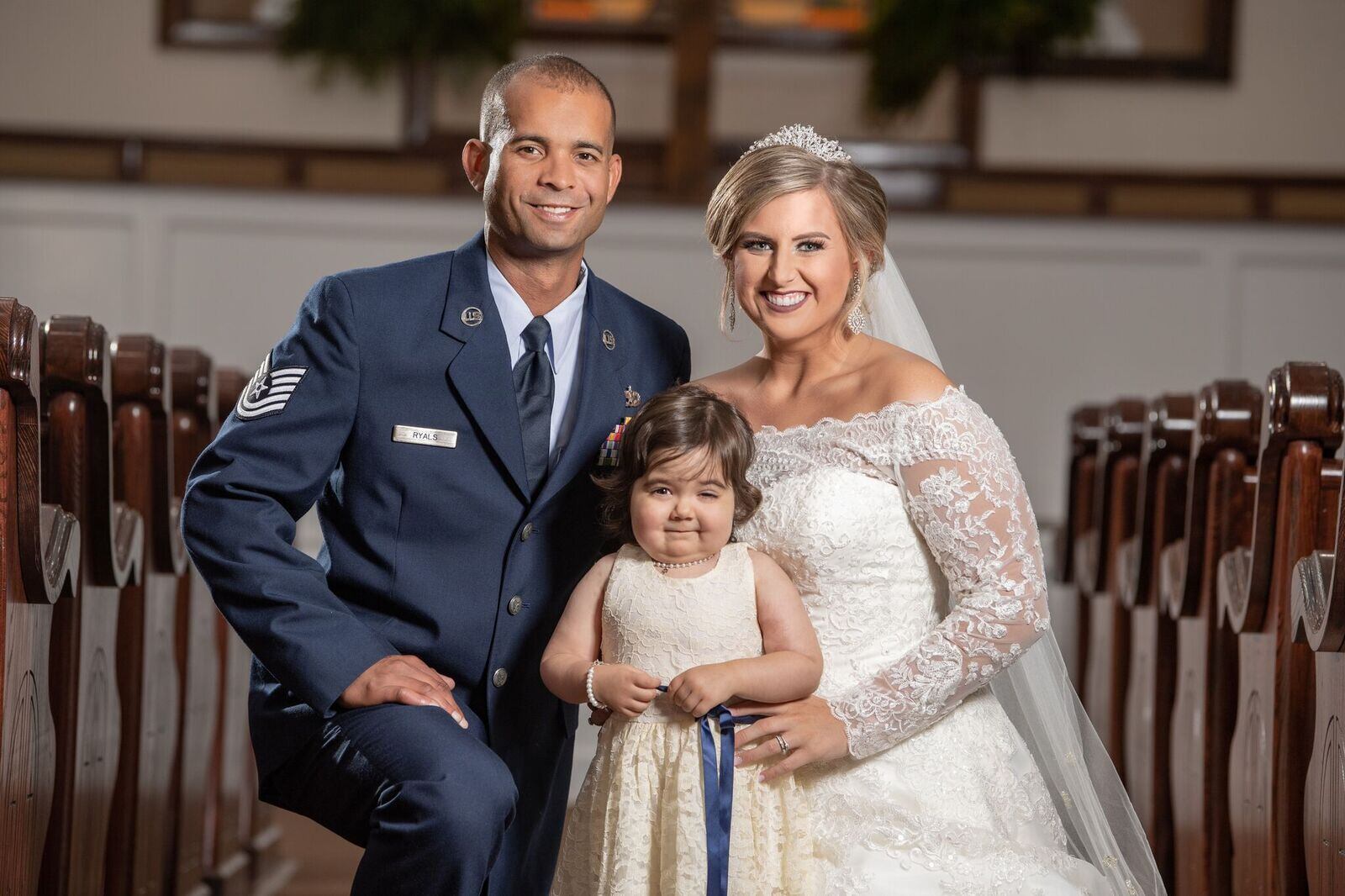 Adrian and Hayden Ryals pose with their flower girl, 3-year-old cancer survivor Skye Savren-McCormick.