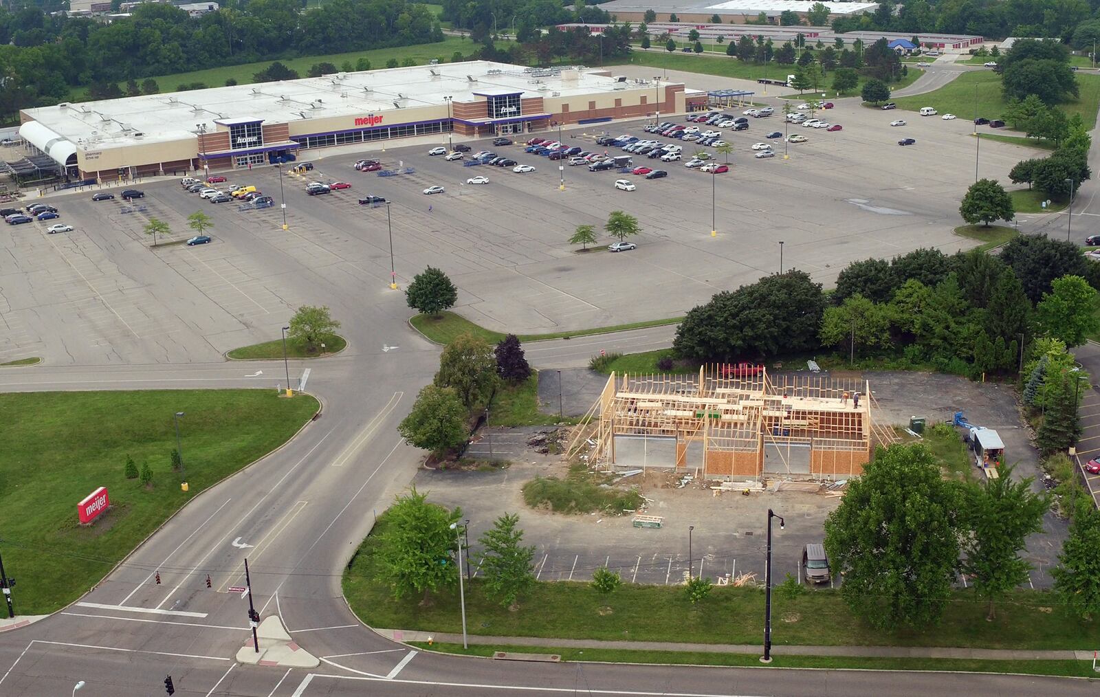 A new Popeye's restaurant is under construction in front of the Meijer store and is one of many new construction projects underway along the Wilmington Pike corridor.   TY GREENLEES / STAFF