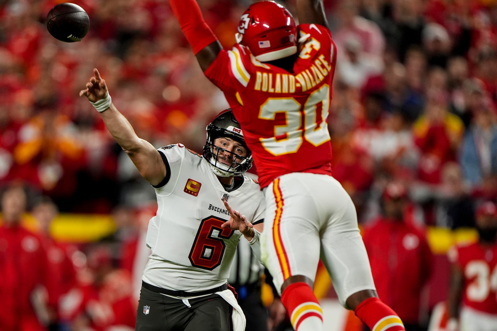 Tampa Bay Buccaneers quarterback Baker Mayfield (6) passes under pressure by Kansas City Chiefs cornerback Christian Roland-Wallace (30) during the first half of an NFL football game, Monday, Nov. 4, 2024, in Kansas City, Mo. (AP Photo/Charlie Riedel)