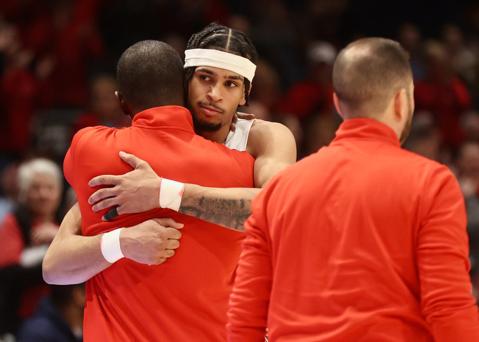 Dayton's Anthony Grant hugs Toumani Camara against La Salle on Tuesday, Feb. 28, 2023, at UD Arena. David Jablonski/Staff