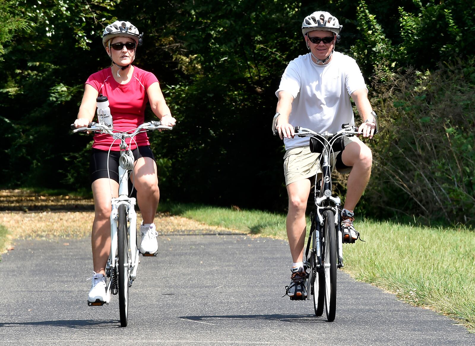 Kim and Jason Allison of Springfield ride their bikes along the Little Miami Scenic Trail in this 2014 file photo. The trail is closed in Milford near the Shawnee Run overpass due to a sinkhole. (Bill Lackey/Staff)