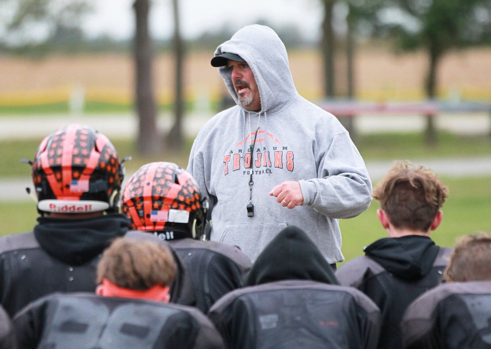 Arcanum head football coach Jason Schondelmyer huddles with the Trojans while preparing for a Week 8 high school football CCC showdown against Covington during practice on Wednesday, Oct. 16, 2019. MARC PENDLETON / STAFF