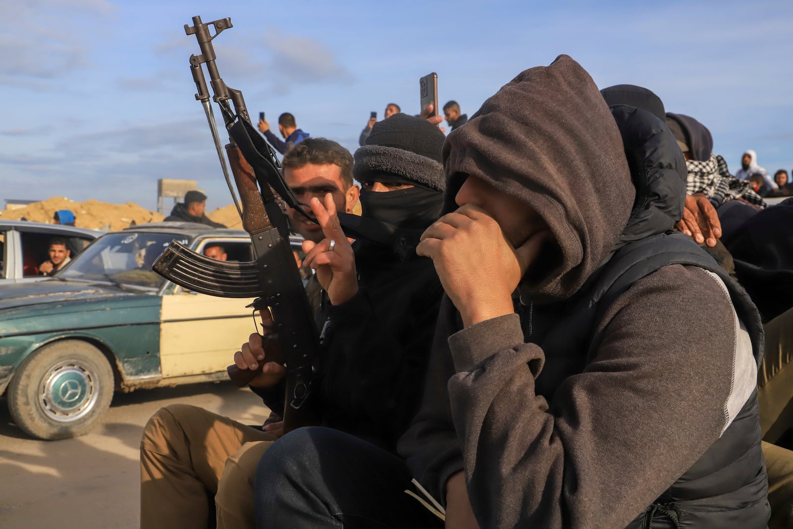 Displaced Palestinians, some armed, return to Rafah, as a ceasefire deal between Israel and Hamas went into effect, in Rafah, Gaza Strip, Sunday, Jan. 19, 2025. (AP Photo/Mariam Dagga)