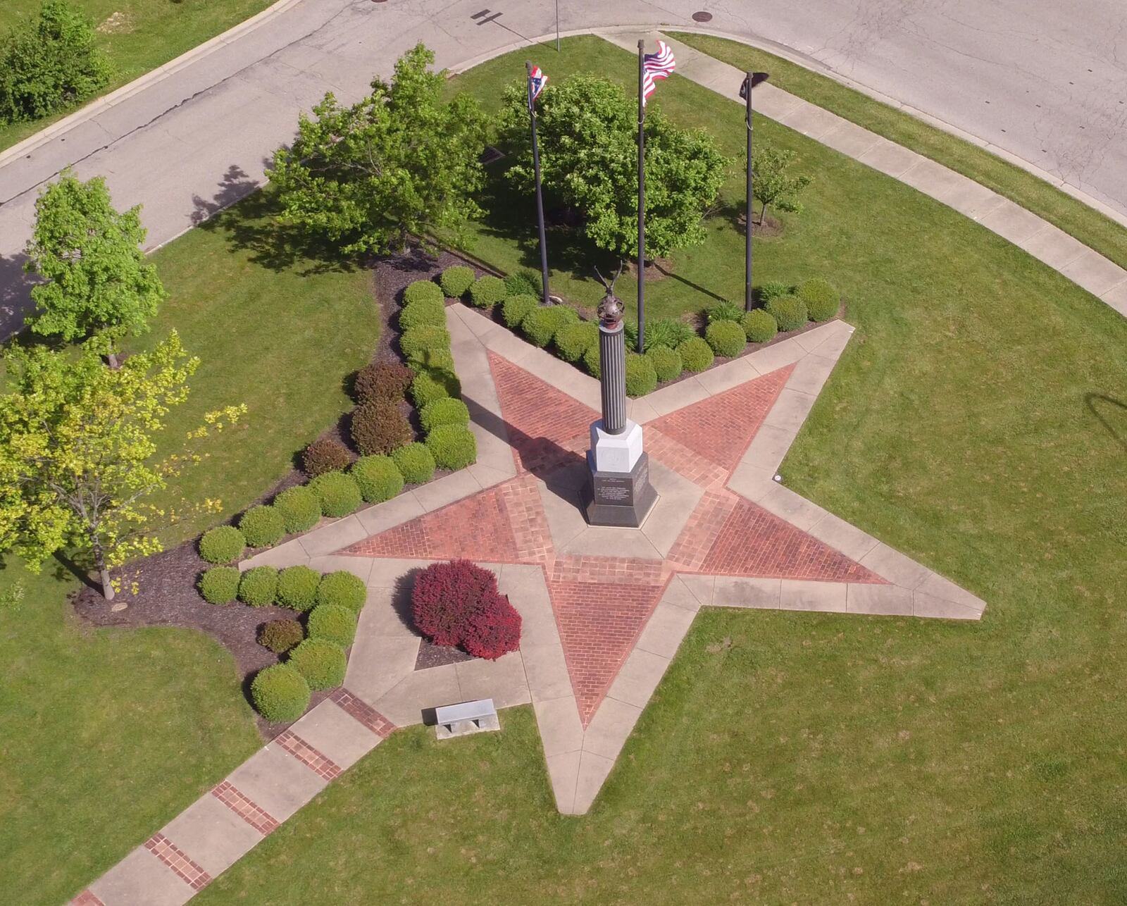 Beavercreek Veterans Memorial is located on North Fairfield Road at Fairwood Drive.  The memorial features a star design and five-sided monument topped with a brass globe and eagle.  Inscribed bricks line the memorial walk.   TY GREENLEES / STAFF