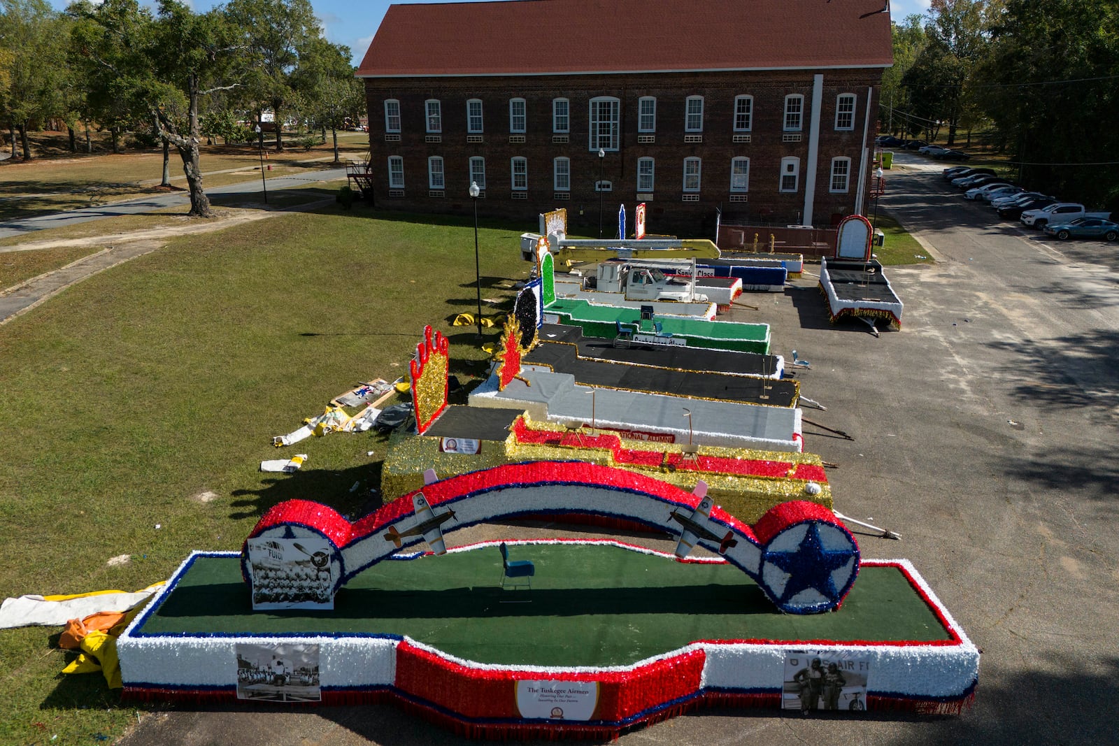 Homecoming parade floats sit on the campus of Tuskegee University a day after a shooting occurred, Monday, Nov. 11, 2024, in Tuskegee, Ala. (AP Photo/Mike Stewart)