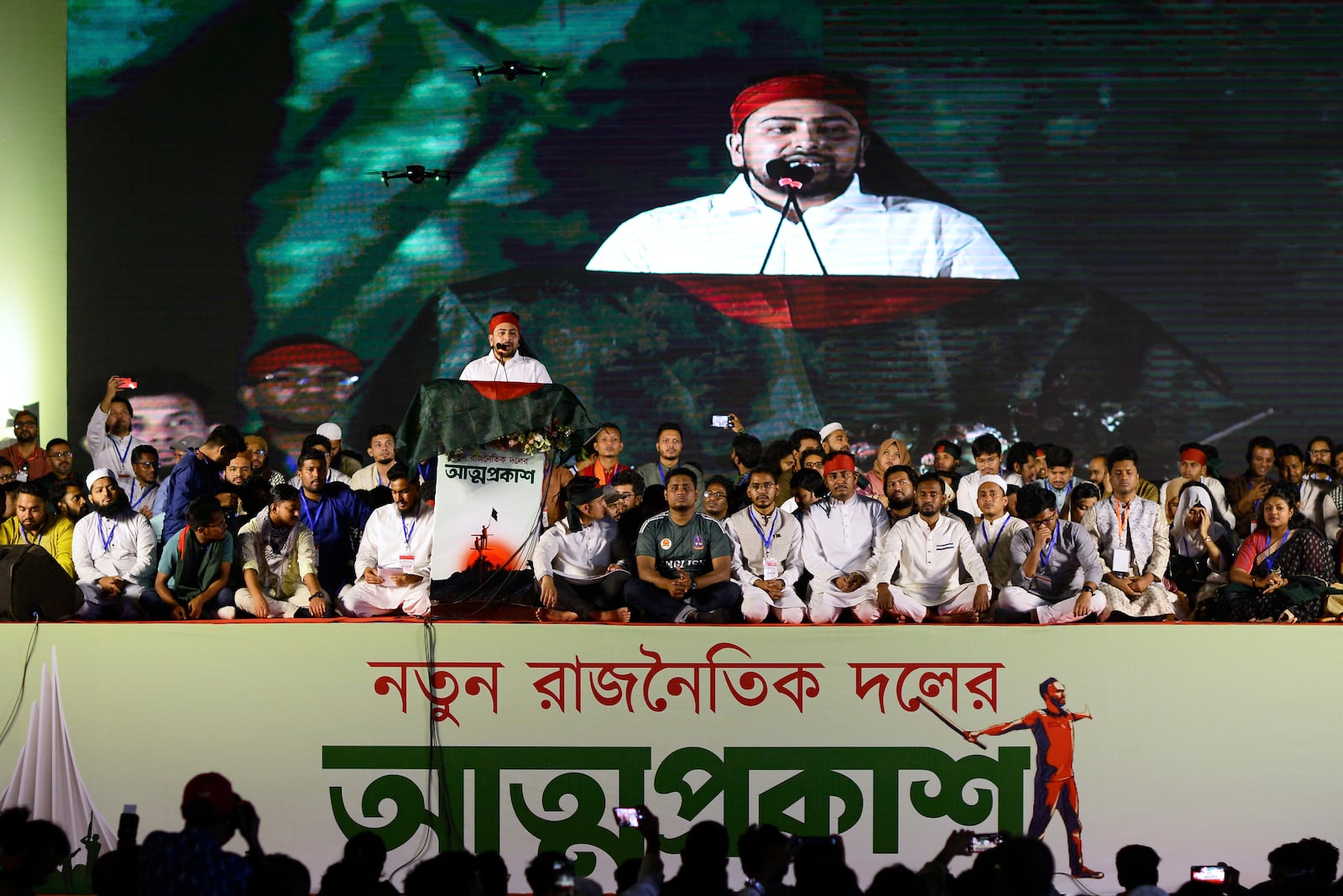 Nahid Islam, who was named as the head of the newly formed Jatiya Nagarik Party, or National Citizen Party, is projected on a digital screen as he speaks to supporters from a podium, in Dhaka, Bangladesh, Friday, Feb. 28, 2025. (AP Photo/Mahmud Hossain Opu)