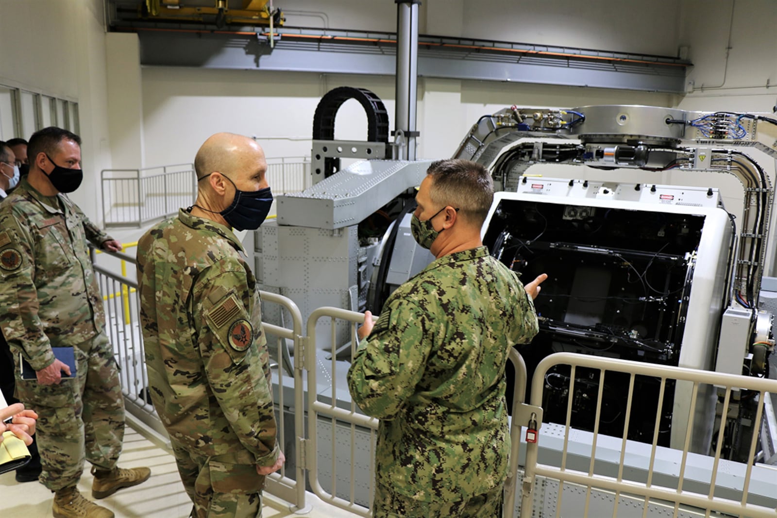 Navy Capt. Richard Folga, department head, Engineering and Technical Services and program manager of the Kraken, Naval Aerospace Medical Research Laboratory, NAMRU-Dayton, and Gen. David Allvin, Air Force vice chief of staff, stand on a balcony in front of the Disorientation Research Device, also known as the Kraken. U.S. NAVY PHOTO/MEGAN MUDERSBACH