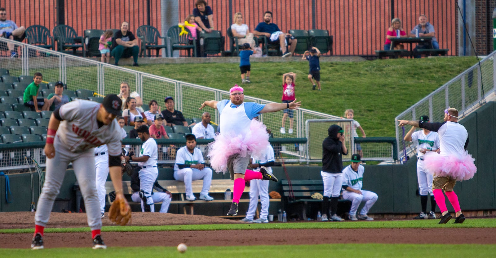 Two Dragons fans dance to the "Nutcracker Suite" between innings in the outfield grass during Wednesday night's game. Jeff Gilbert/CONTRIBUTED