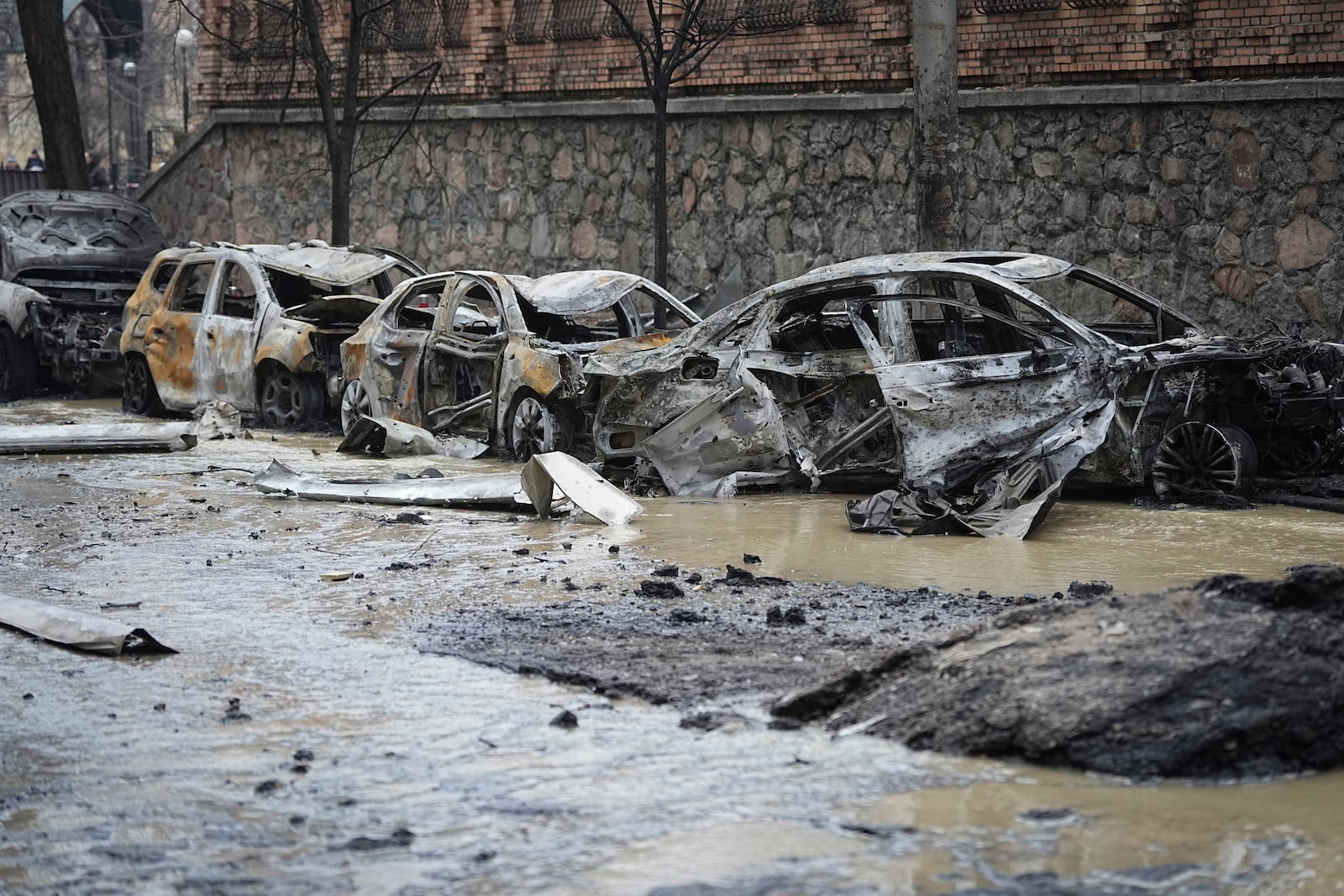 Cars are seen damaged after recent Russian attacks in Kyiv, Ukraine, Friday, Dec. 20, 2024. (AP Photo/Efrem Lukatsky)