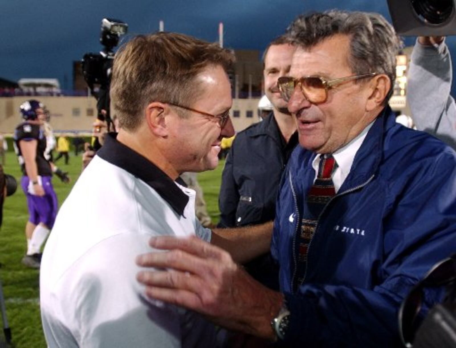 Northwestern head coach Randy Walker congratulates Penn State head coach Joe Paterno after Paterno's Nittany Lions defeated Northwestern 38-35 on Saturday, Oct. 20, 2001 in Evanston, Ill. Penn State's victory over Northwestern tied Paterno with Bear Bryant for the record for the most college football coaching victories. (AP Photo/Stephen J. Carrera)