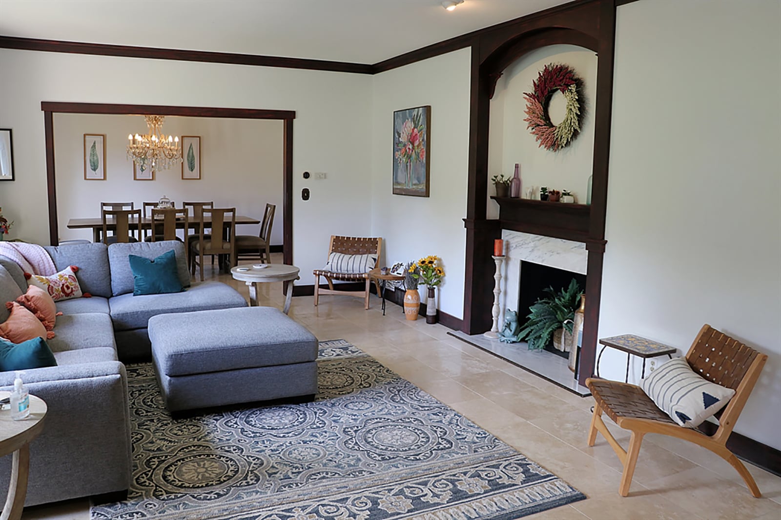 Three arched windows fill the living room with natural light, and crown molding creates an artwork and drapery rail. The wood work continues around the decorative marble fireplace and forms a wooden mantel shelf and arched accents. CONTRIBUTED PHOTO BY KATHY TYLER