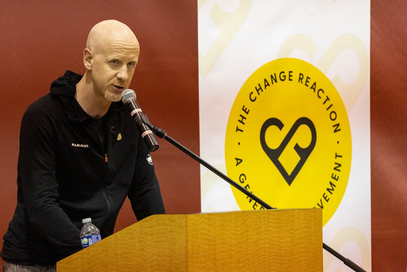 GoFundMe CEO Tim Cadogan delivers a speech as he attends an event at the gymnasium of Pasadena City College where The Change Reaction will be handing out about 1,000 checks of between $2,500-$5,000, Tuesday, Jan. 28, 2025 in Pasadena, Calif. (AP Photo/Etienne Laurent)