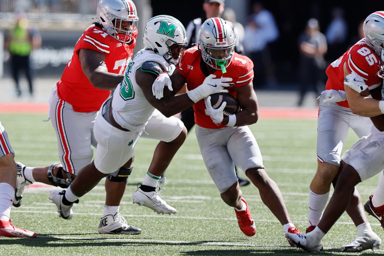 Ohio State running back Quinshon Judkins, right, is tackled by Marshall defensive lineman J.J. Hawkins during the second half of an NCAA college football game Saturday, Sept. 21, 2024, in Columbus, Ohio. (AP Photo/Jay LaPrete)