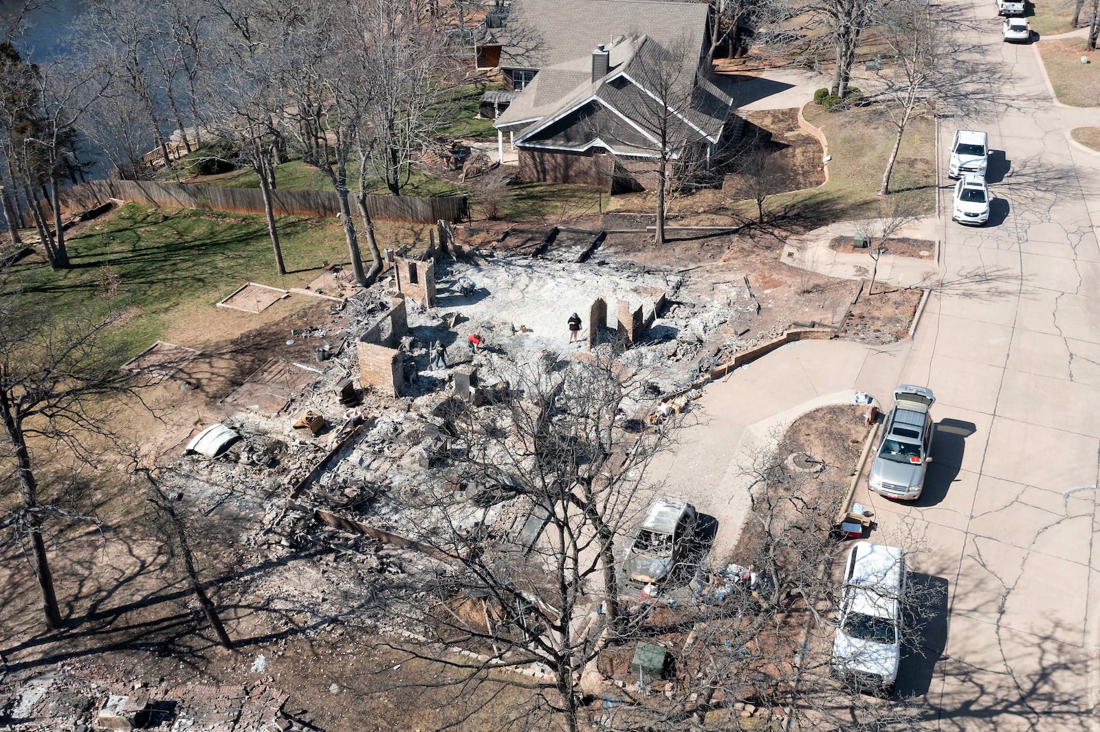 An aerial view of Andrine Shufran's burned home in the Hidden Oaks neighborhood in Stillwater, Okla., Monday, March 17, 2025, after wildfires burned through the area Friday. (AP Photo/Alonzo Adams)