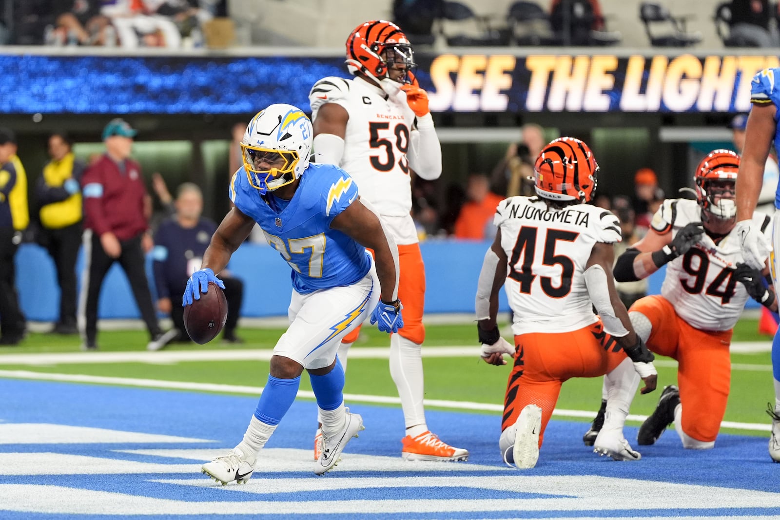 Los Angeles Chargers running back J.K. Dobbins (27) scores a rushing touchdown during the first half of an NFL football game against the Cincinnati Bengals, Sunday, Nov. 17, 2024, in Inglewood, Calif. (AP Photo/Gregory Bull)