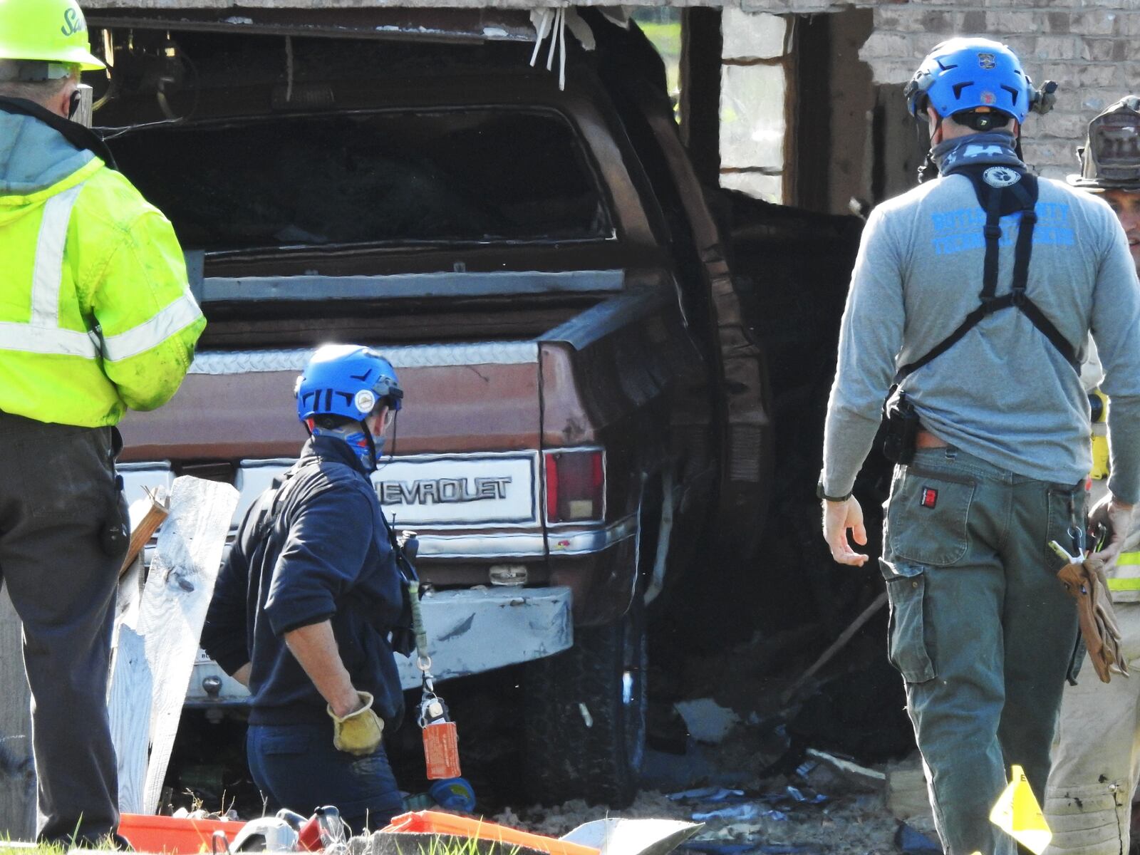 Emergency units work to remove a truck that slammed into a Monroe house this morning NICK GRAHAM/STAFF