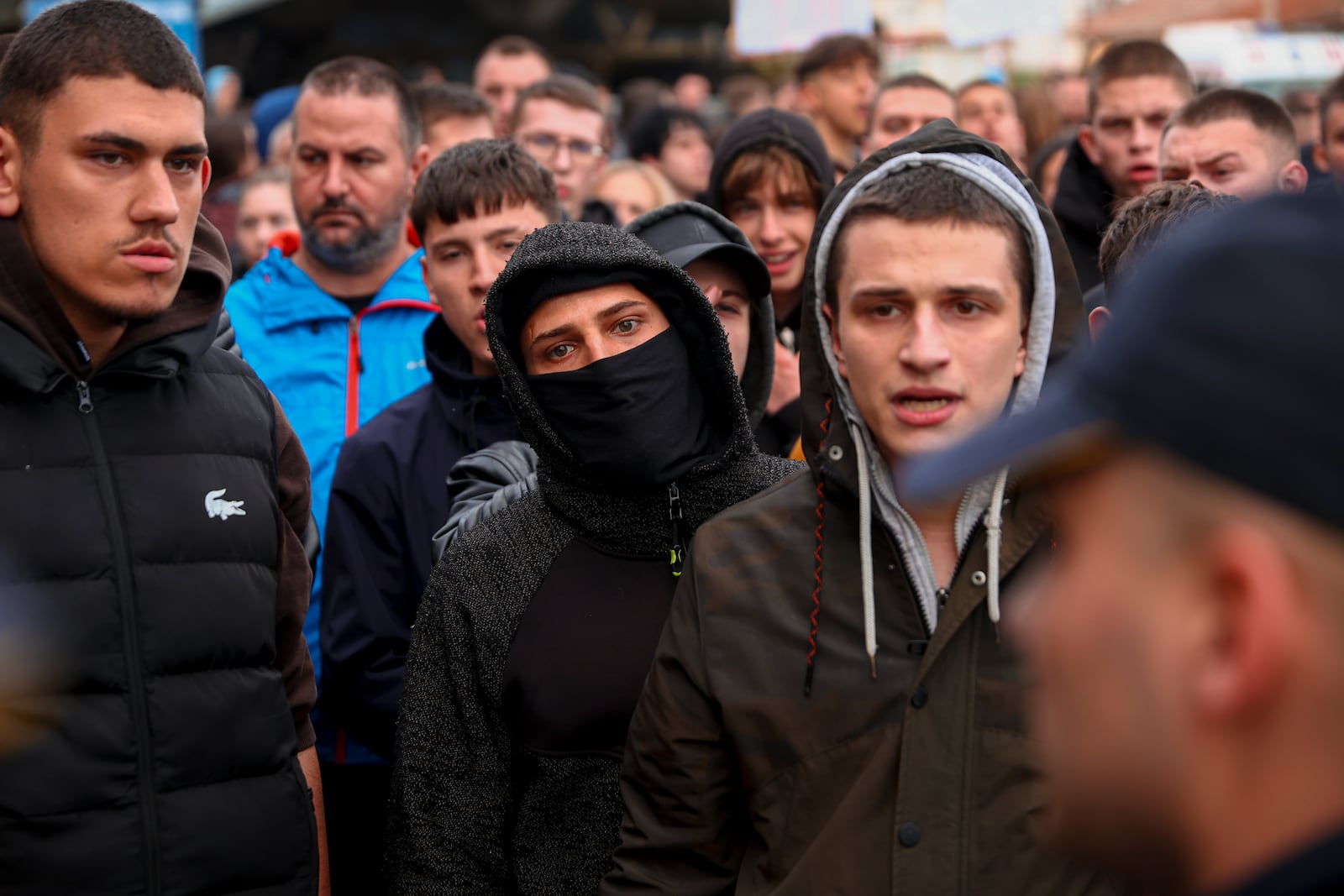 People argue with policemen, outside the home of the owner of a nightclub that was the scene of a massive fire, after a vigil for the victims in the town of Kocani, North Macedonia, Monday, March 17, 2025. (AP Photo/Armin Durgut)