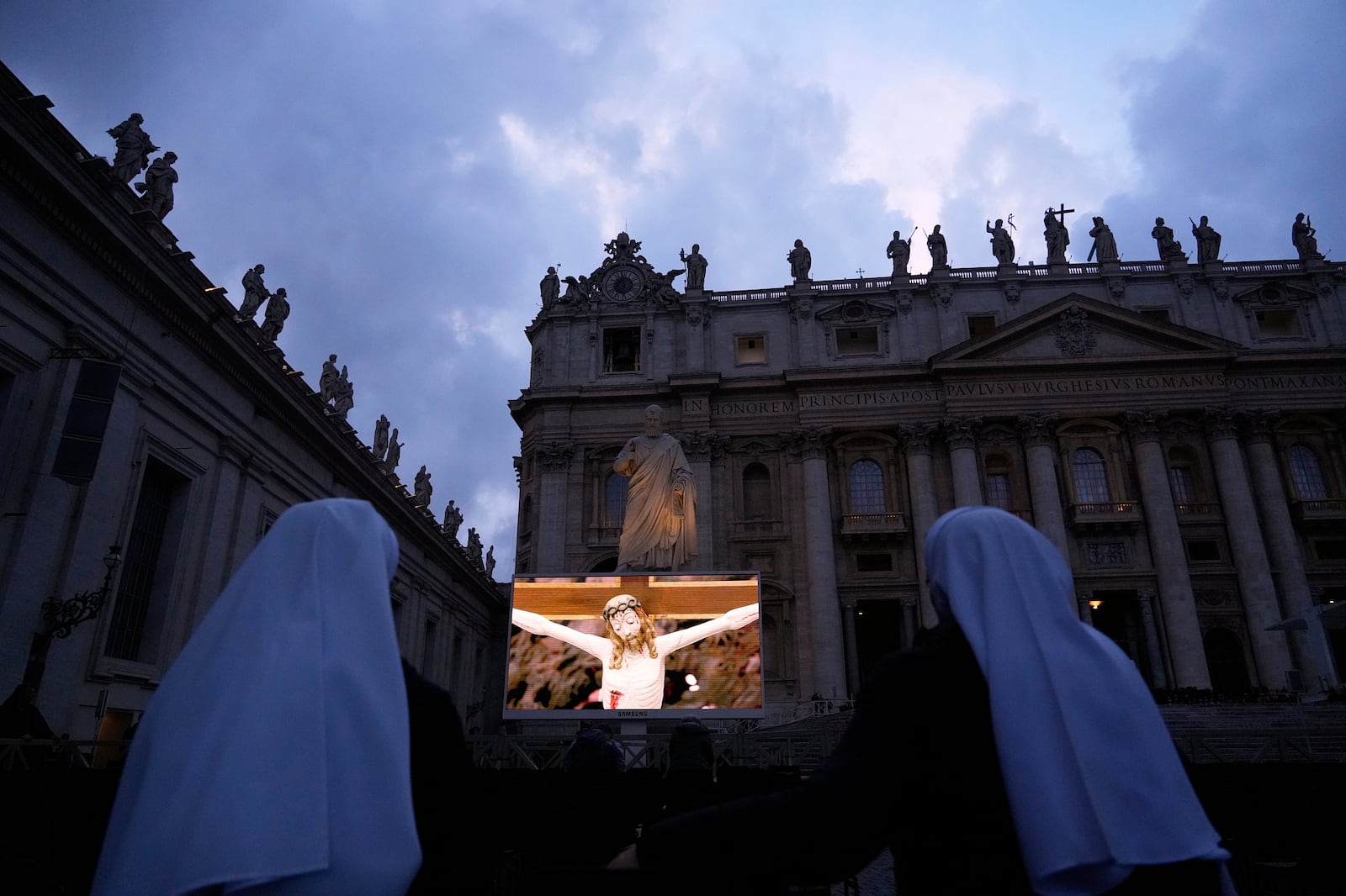 Nuns wait in St. Peter's Square at the Vatican for the start of a vigil rosary for the recovery of Pope Francis being treated for pneumonia at Rome's Agostino Gemelli Polyclinic, Thursday, March 13, 2025. (AP Photo/Gregorio Borgia)