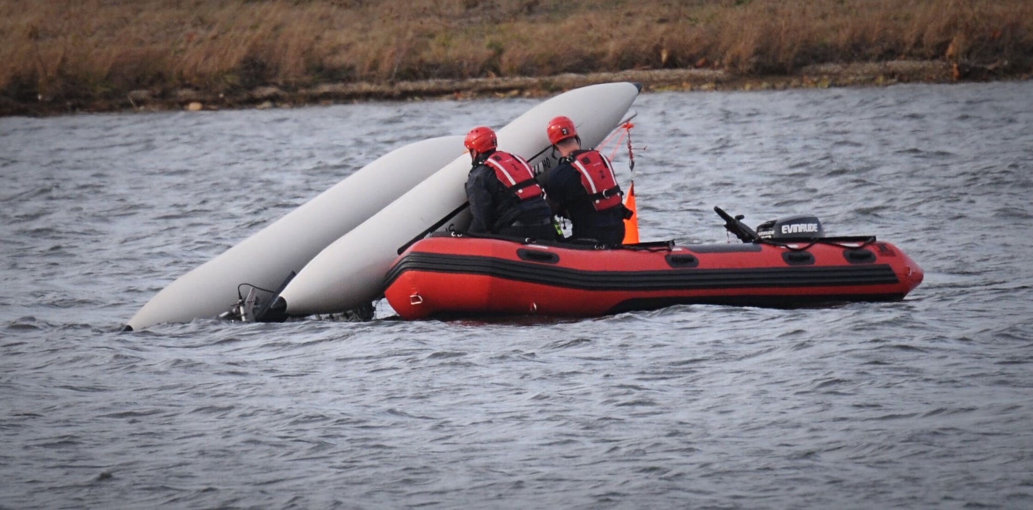 Man, dog rescued after boat overturns