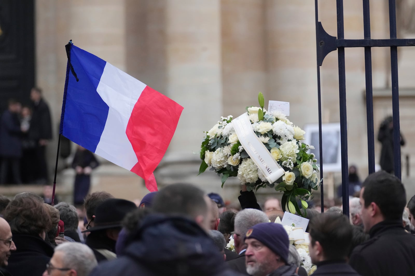 People wait outside Notre Dame du Val-de-Grace church before a public memorial for late far-right leader Jean-Marie Le Pen, Thursday, Jan. 16, 2025 in Paris. Jean-Marie Le Pen, the founder of France's main far-right party, died on Jan.7, 2025 aged 96. (AP Photo/Thibault Camus)