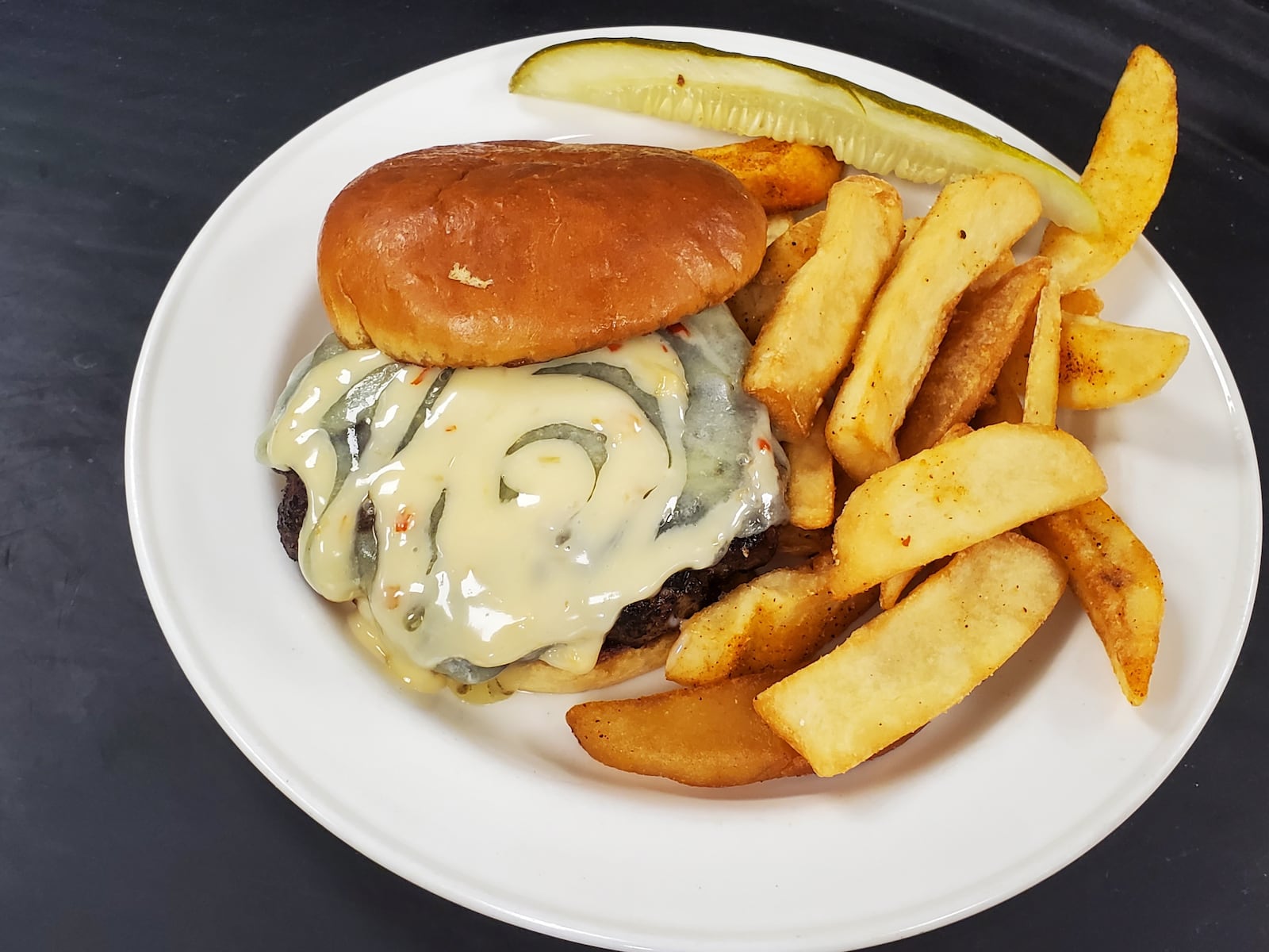 Bullwinkle's is offering its Bab Burger ($11.99), a 50/50 Sausage blend, white cheddar, sweet chili mayo, brioche bun, during Burger Week June 21-28, 2020. CONTRIBUTED