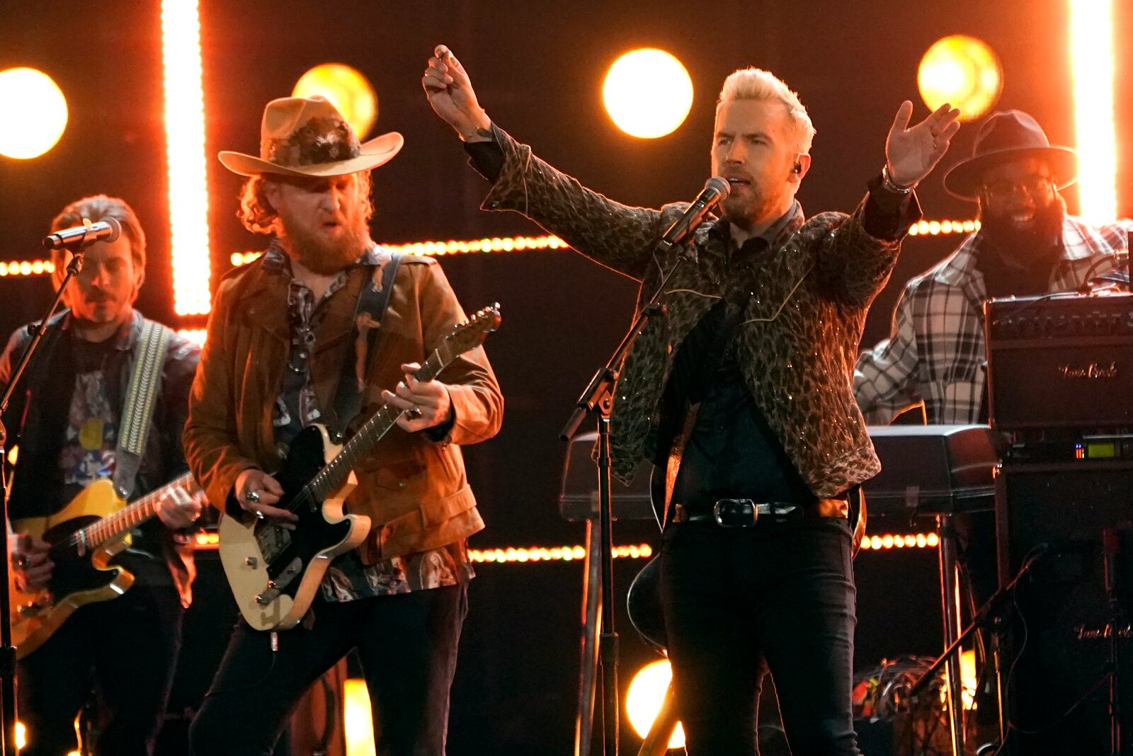 John Osborne, left, and T.J. Osborne of Brothers Osborne performs "Dead Man's Curve" at the 64th Annual Grammy Awards on Sunday, April 3, 2022, in Las Vegas. They will perform Aug. 26, 2022 at the Rose Music Center at The Heights. (AP Photo/Chris Pizzello)