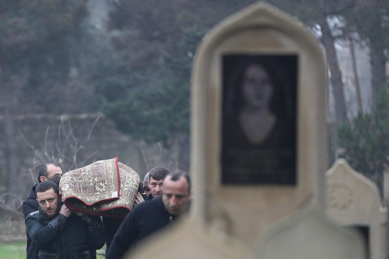 People carry the body of Mahammadali Eganov, 13 who died in the Azerbaijan Airlines Embraer 190 crash near Kazakhstan's Aktau airport, at his funeral, in Baku, Azerbaijan, Saturday, Dec. 28, 2024. (AP Photo)