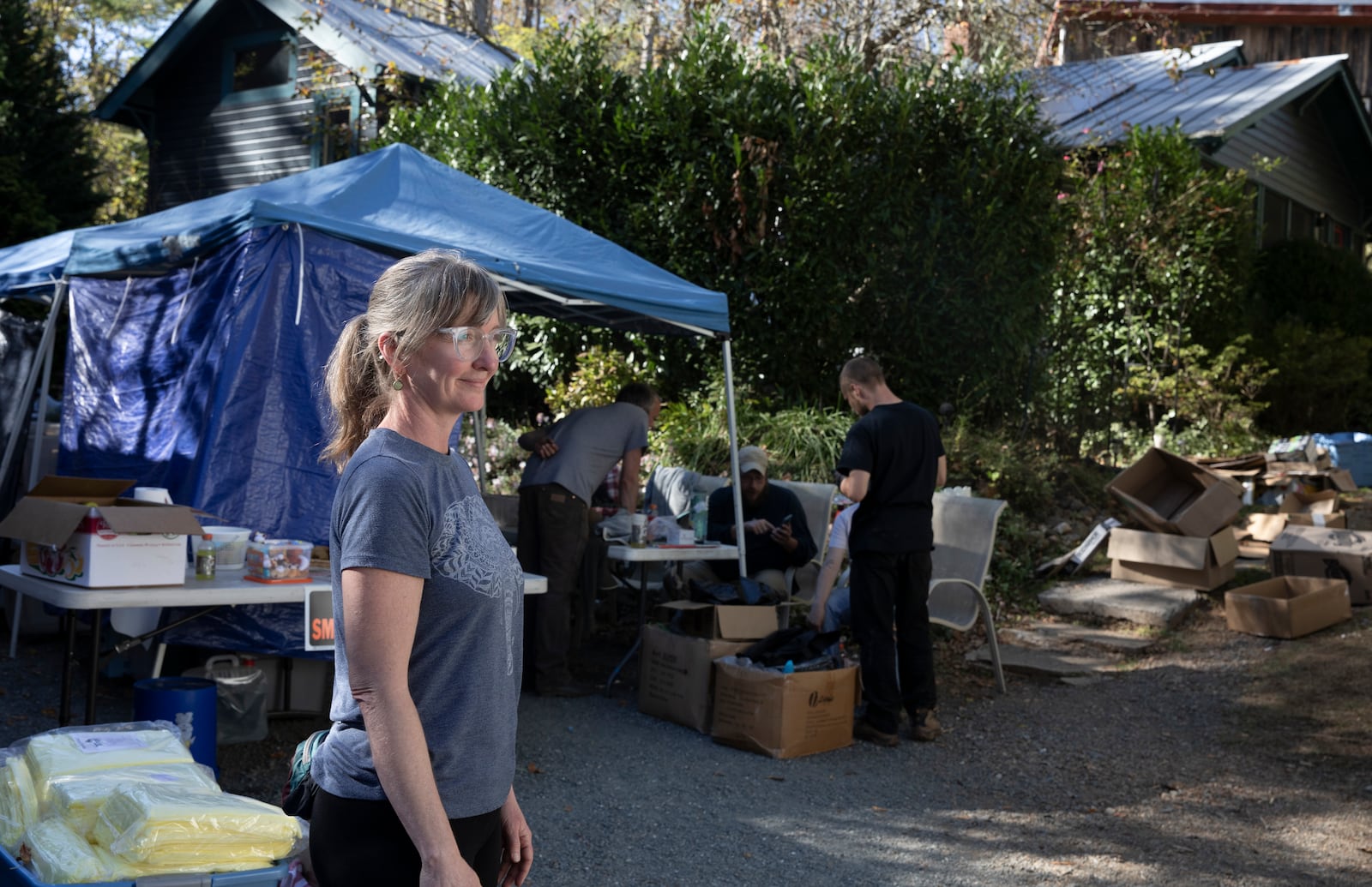 Julie Wiggins stands in front of the makeshift distribution hub staged in front of her home in Bakersville, N.C. on Oct. 9, 2024.on Oct. 9, 2024. (AP Photo/Gabriela Aoun Angueria)