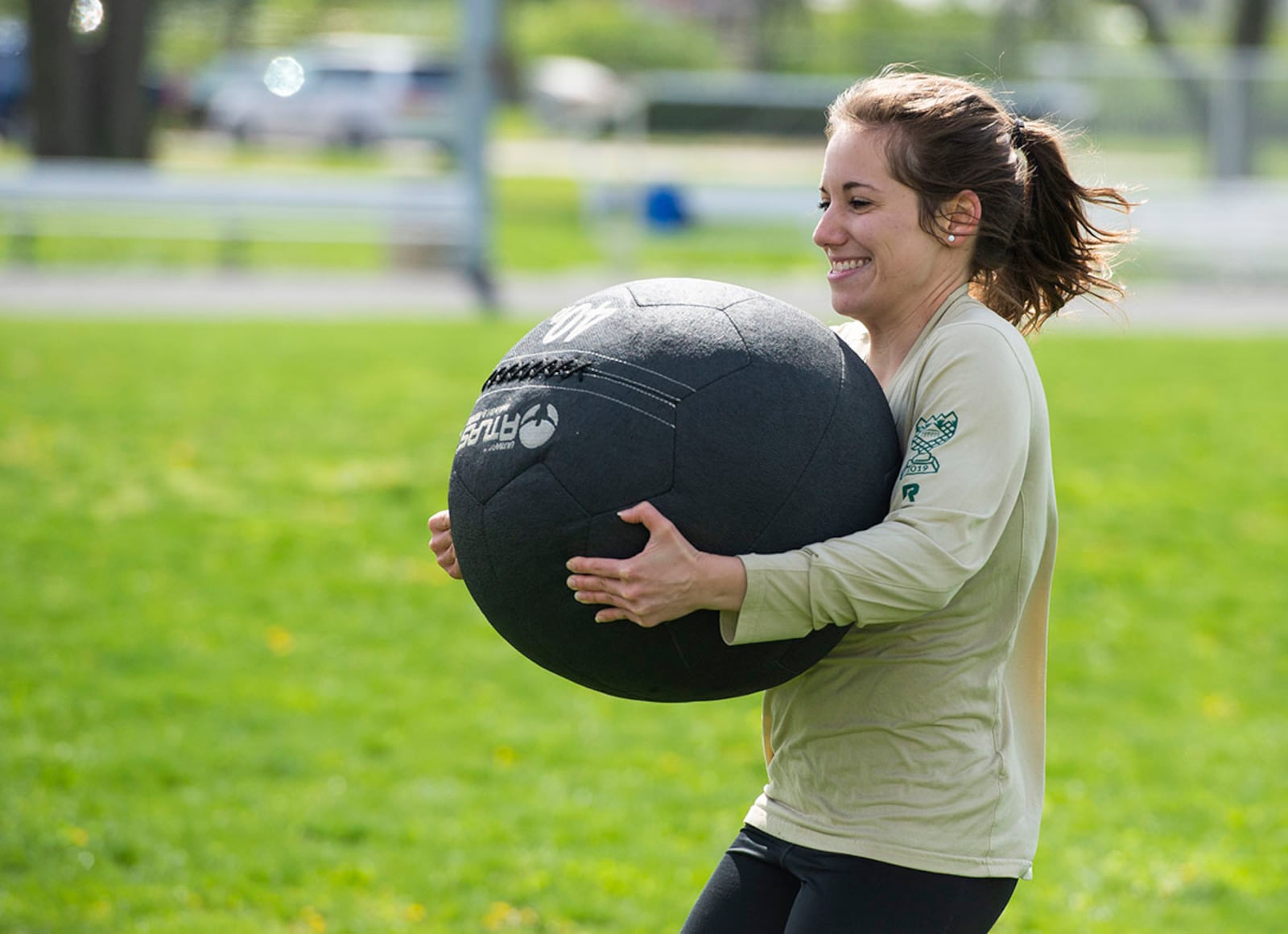 Sophia Angelopoulos, Air Force Research Laboratory assistant research chemist, races between lines with a medicine ball April 15 during a timed event at the All-Star Fitness Challenge on Wright-Patterson Air Force Base. U.S. AIR FORCE PHOTO/WESLEY FARNSWORTH