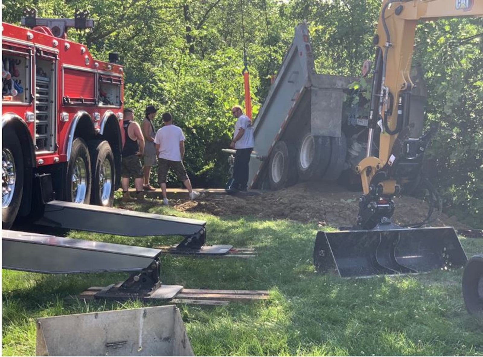 Two heavy wreckers were needed to pull a dump truck that was hanging over a culvert in Deerfield Twp. on Friday afternoon. Diesel fuel and oil leaked into Simpson's Creek which takes water into Landen Lake. An environmental clean up crew was called in to help mitigate the damage. ED RICHTER/STAFF