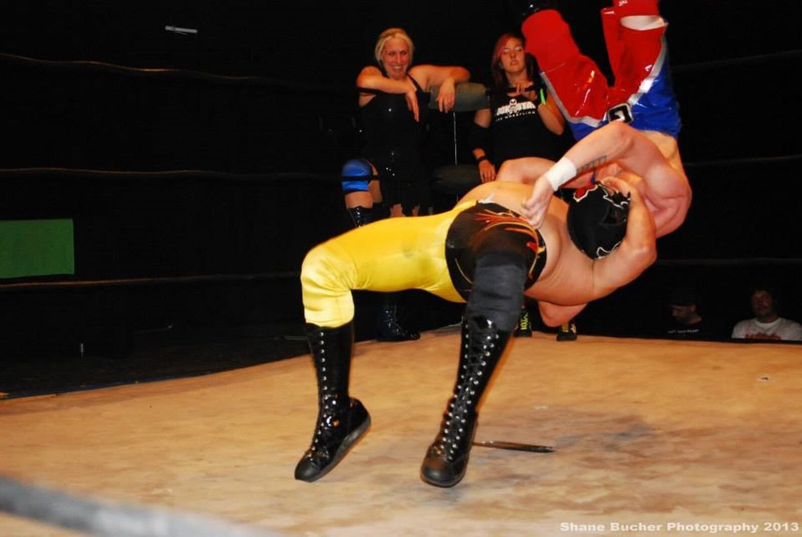 Jeremy Ganger (in yellow tights) in the midst of slamming an opponent in a wrestling match. CONTRIBUTED