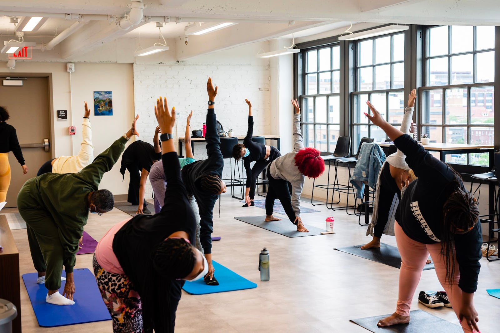 Attendees are being led through a movement and meditation offering titled Fierce and Fluid by curator and yogi Tobi Ewing at Scripted in Black's FemmeDomHood event series: A safe space for Black and Brown women to gather, heal and grow.