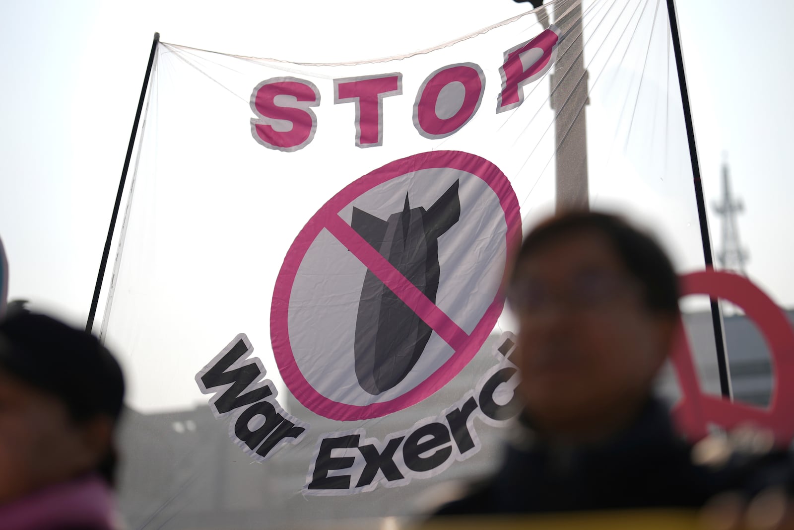 Protesters shout slogans during a press conference demanding to stop the upcoming Freedom Shield military exercise between the U.S. and South Korea, near the Defense Ministry in Seoul, South Korea, Monday, March 10, 2025. (AP Photo/Lee Jin-man)