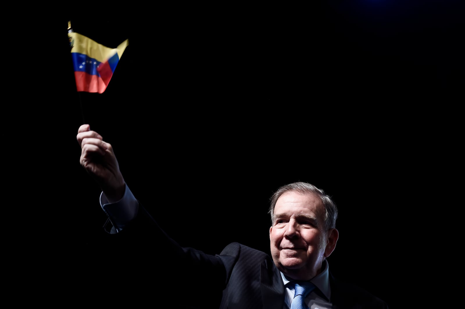 Venezuela's opposition leader Edmundo Gonzalez, who has been recognized by several governments including the U.S. as Venezuela's president-elect, waves a Venezuelan flag during a meeting with supporters in Panama City, Jan. 8, 2025, two days ahead of Maduro's inauguration ceremony where he will be sworn in for a third term. (AP Photo/Agustin Herrera)