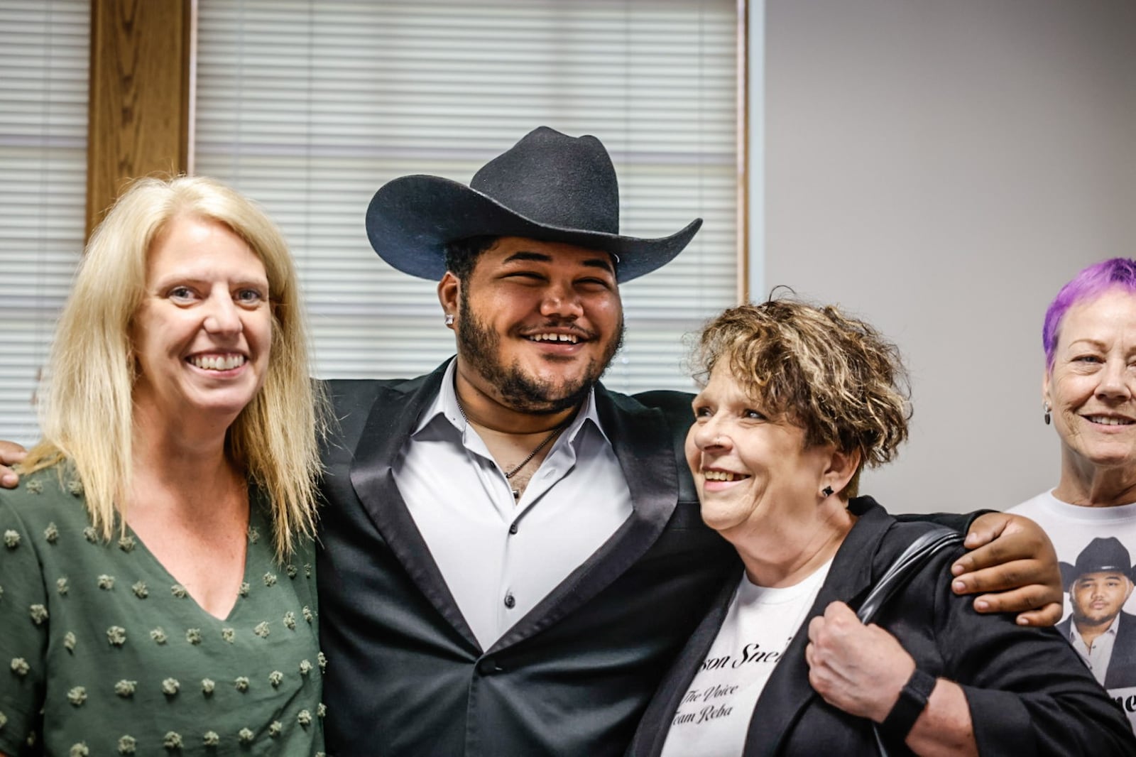 From left, Jennifer Stokes, Jackson Snelling, Dacia Snelling and Pam Brown get a group photo at the Montgomery County Children Services. Stokes was Snelling adoption social worker. Dacia Snelling is Jackson's mother and Brown is Jackson's sister-in-law. JIM NOELKER/STAFF