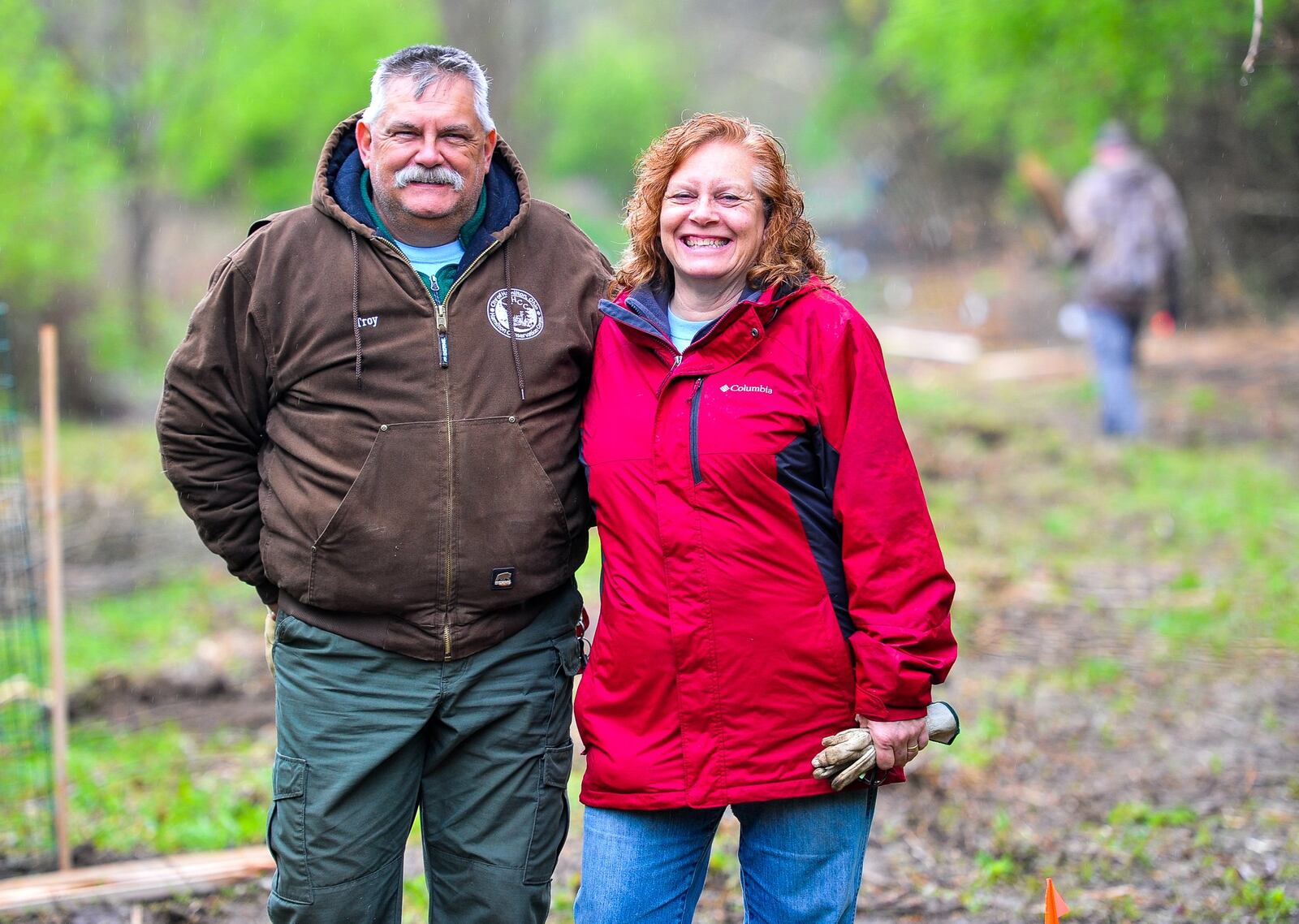 Troy and Kathy Schwable stand in a clearing where 100 trees are being planted by members of Hamilton Conservation Corps. and Hamilton city employees at Riverside Natural Area. NICK GRAHAM/STAFF