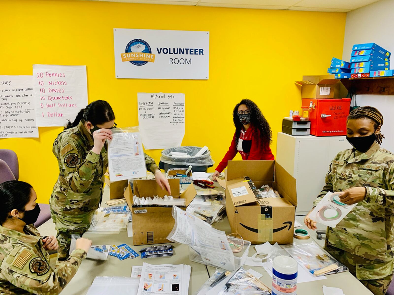 Volunteers from the National Air and Space Intelligence Center on Wright-Patterson Air Force Base organize school supplies on Feb. 26 at Crayons to Classrooms. Crayons to Classrooms helps provide free educational supplies for teachers. CONTRIBUTED PHOTO