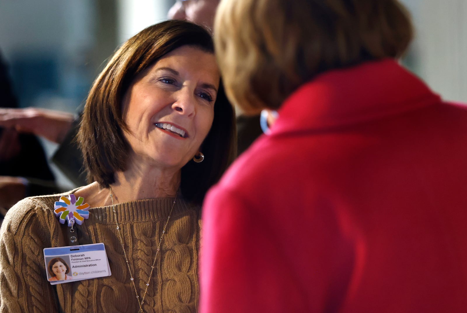 Deborah Feldman, president and CEO of Dayton Children's Hospital, talks with Montgomery County Commissioner Judy Dodge Thursday, Dec. 5, 2024 during a recent event recognizing the start of construction for the health system's kinship housing development project. MARSHALL GORBY\STAFF