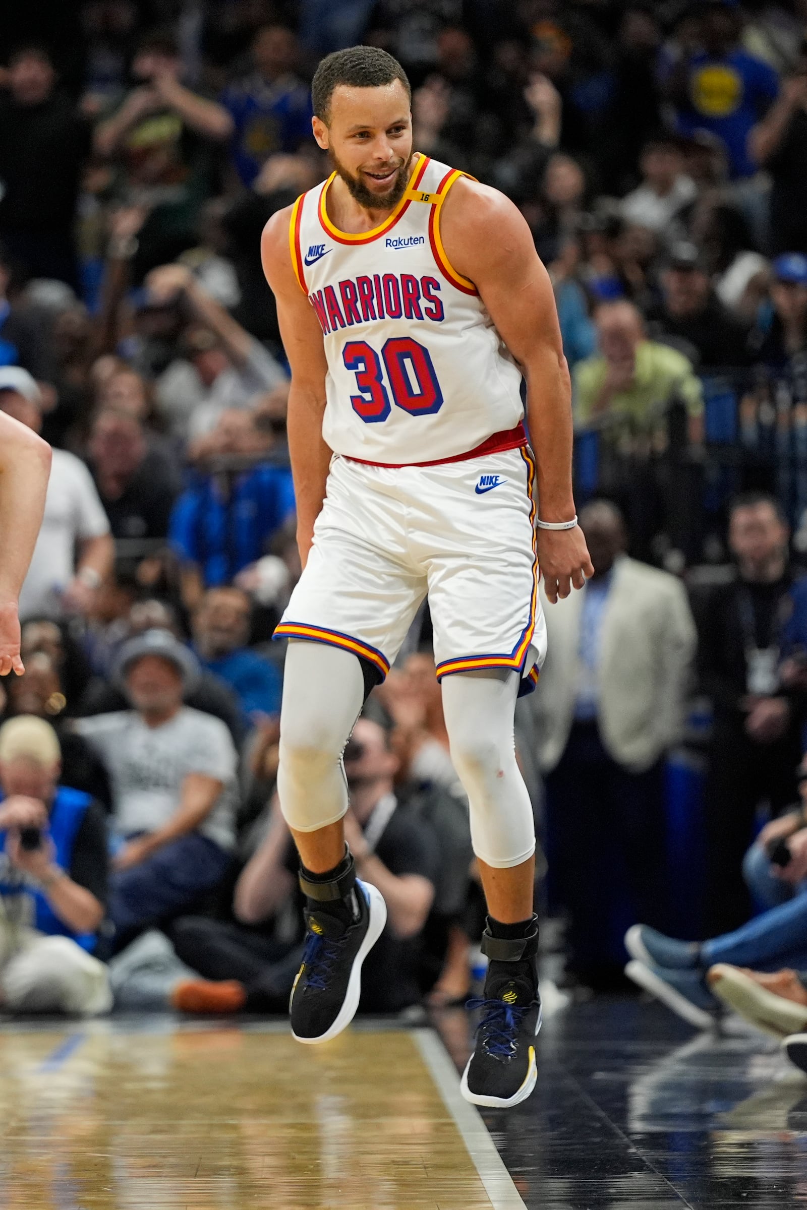 Golden State Warriors guard Stephen Curry (30) reacts in front of fans after sinking a 3-point shot against the Orlando Magic during the second half of an NBA basketball game, Thursday, Feb. 27, 2025, in Orlando, Fla. (AP Photo/John Raoux)