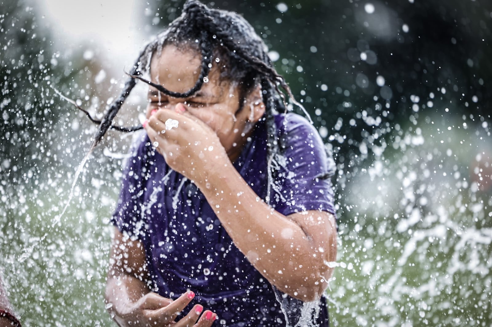 Sirius Sol Mathews, from Dayton, enjoys the splash pad at W.S. Mcintosh Park in Dayton. Temperatures are expected to reach the 90s this week. JIM NOELKER/STAFF