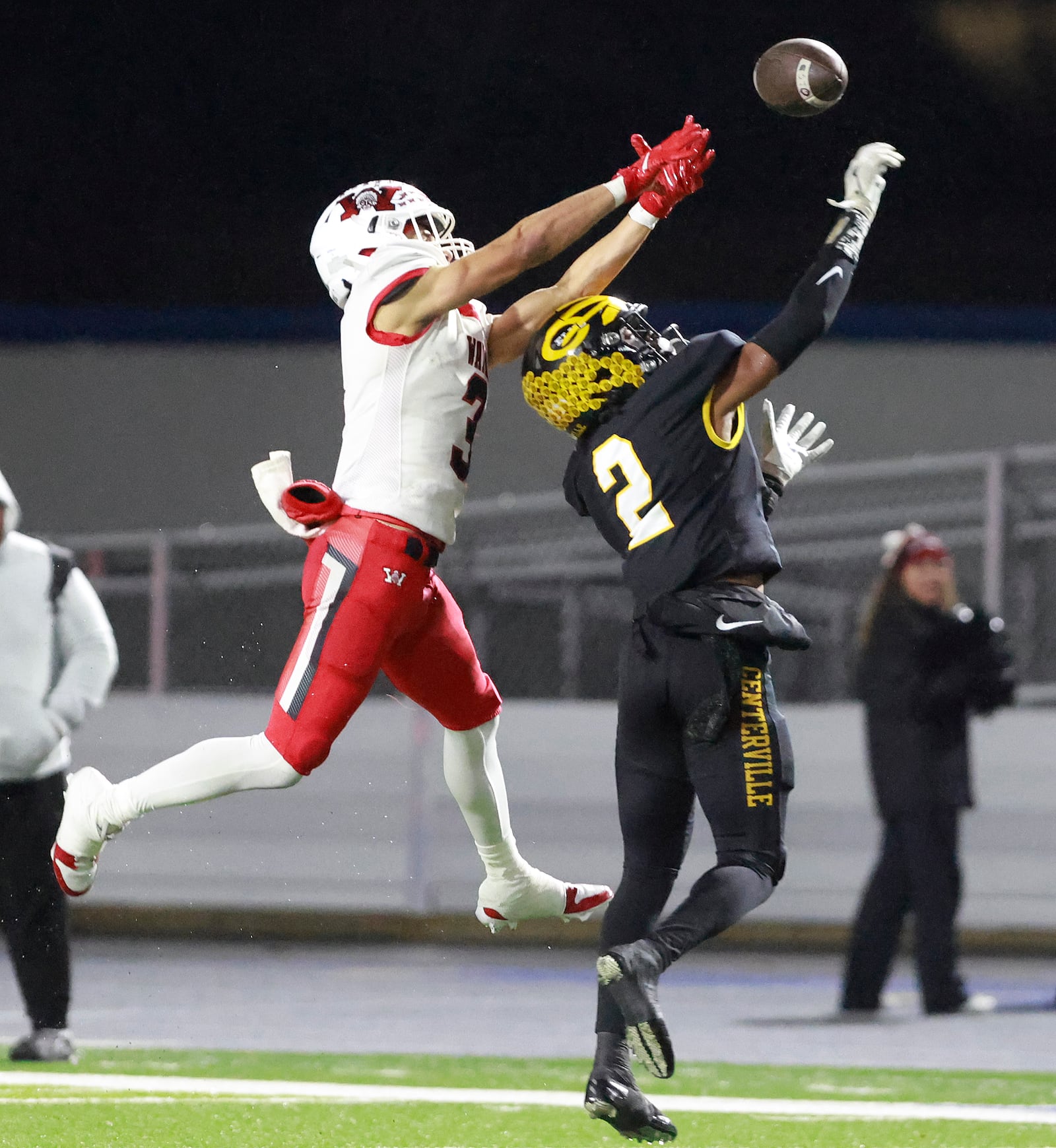 Centerville's Quinten Robinson breaks up a Wayne pass meant for Teaunn Hunter during their Regional championship game at Welcome Stadium Friday. BILL LACKEY/STAFF