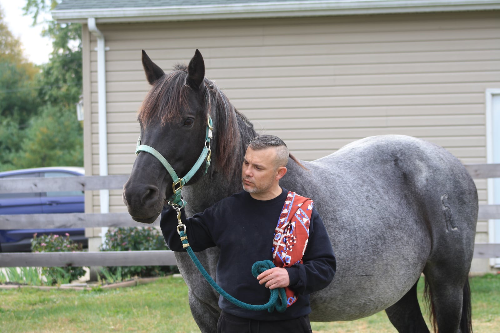 A veteran who is part of he W.I.S.H. program at the Therapeutic Riding Institute (TRI) works with a horse. CONTRIBUTED