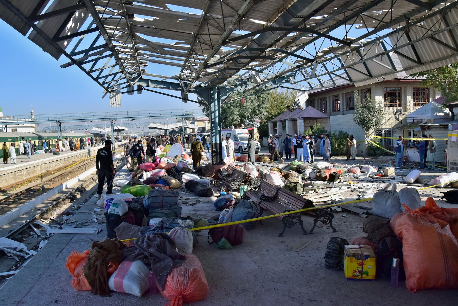 Security officials examine the site of a bomb explosion at railway station in Quetta, southwestern Pakistan, Saturday, Nov. 9, 2024. (AP Photo/Arshad Butt)