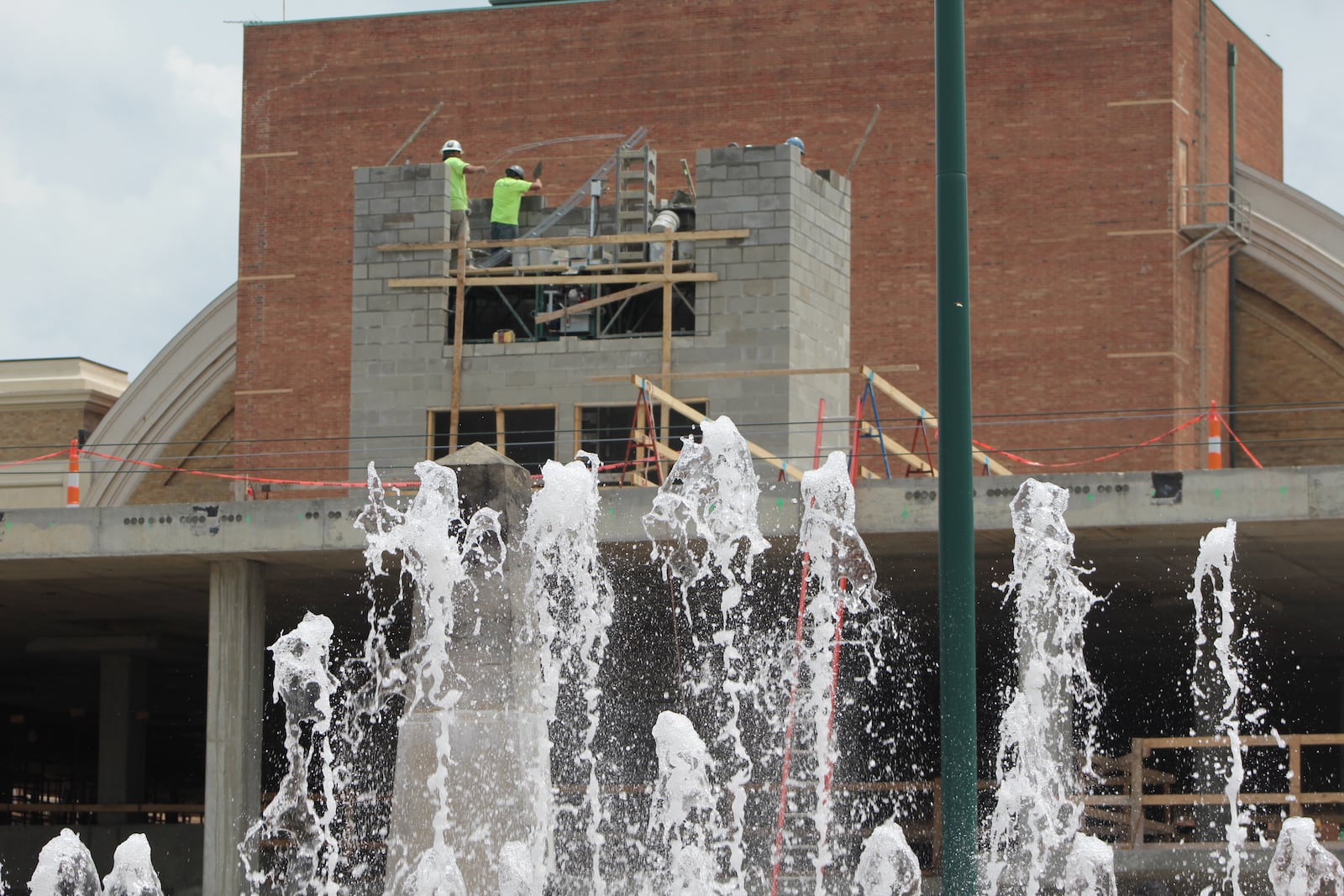 Construction crews work on the Monument apartments, across from RiverScape MetroPark, over the summer. CORNELIUS FROLIK / STAFF