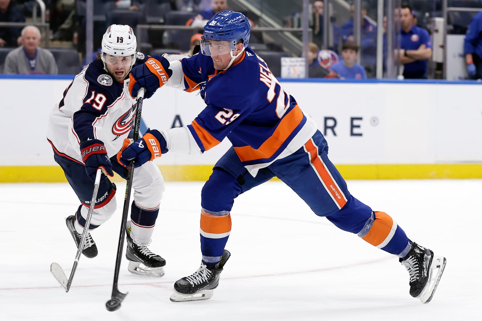 New York Islanders center Brock Nelson, right, shoots in front of Columbus Blue Jackets center Adam Fantilli, left, in the second period of an NHL hockey game Monday, Jan. 20, 2025, in Elmont, N.Y. (AP Photo/Adam Hunger)