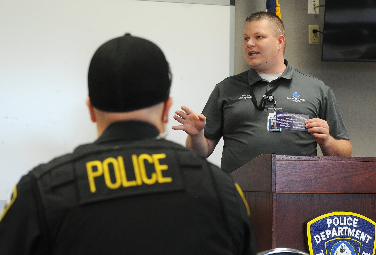 Moraine Heights Baptist Church pastor Patrick Dell'Aria talks with Miami Twp. police officers, Wednesday, May 12, 2021. MARSHALL GORBY/STAFF