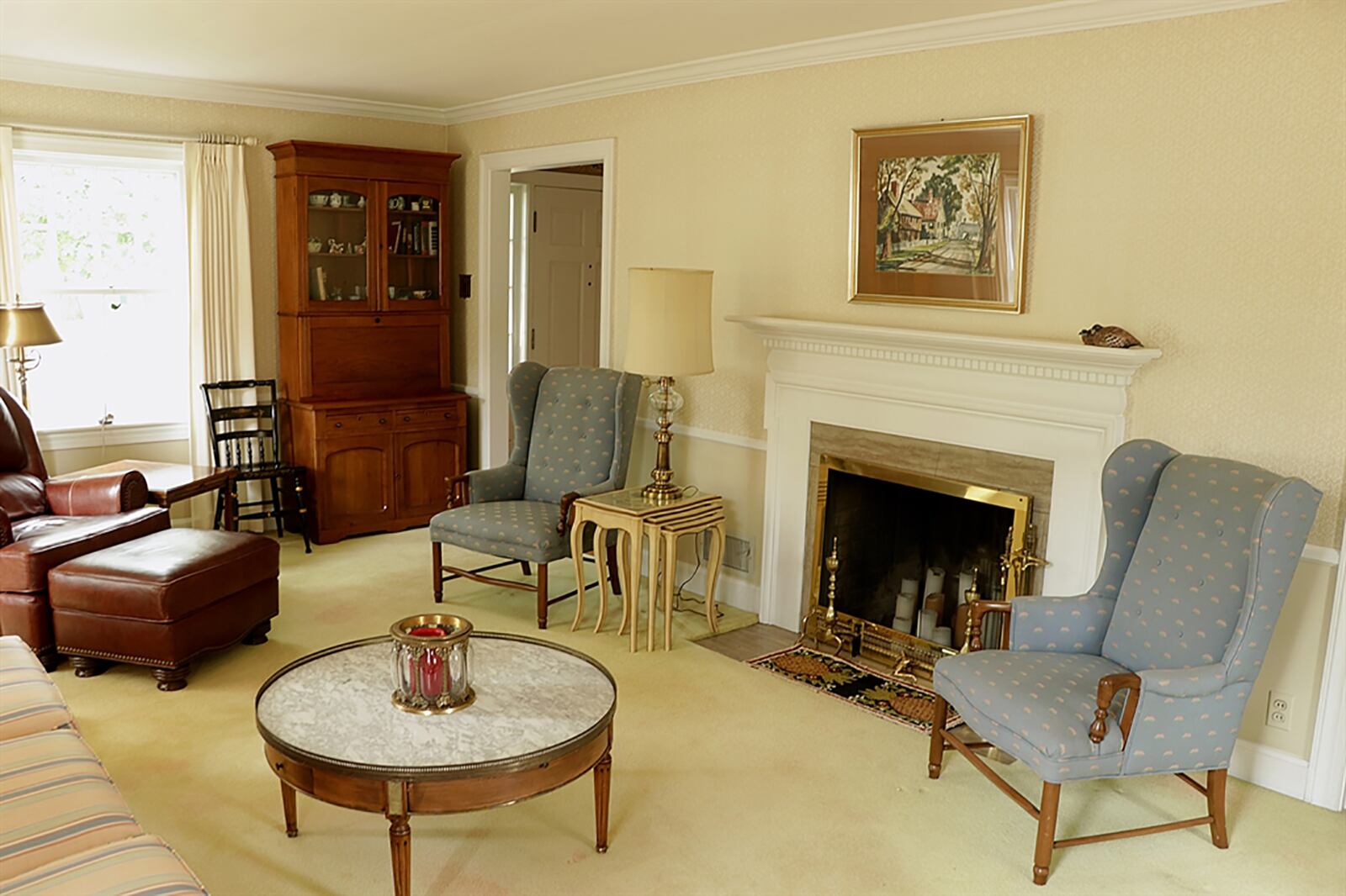 The formal living room extends the length of the house with several tall windows. A wood-burning fireplace has a wood mantel and marble hearth and surround. CONTRIBUTED PHOTO BY KATHY TYLER